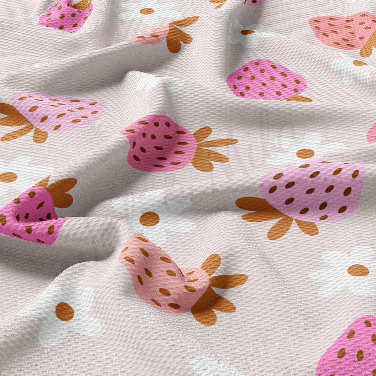 a close up of a white fabric with strawberrys on it