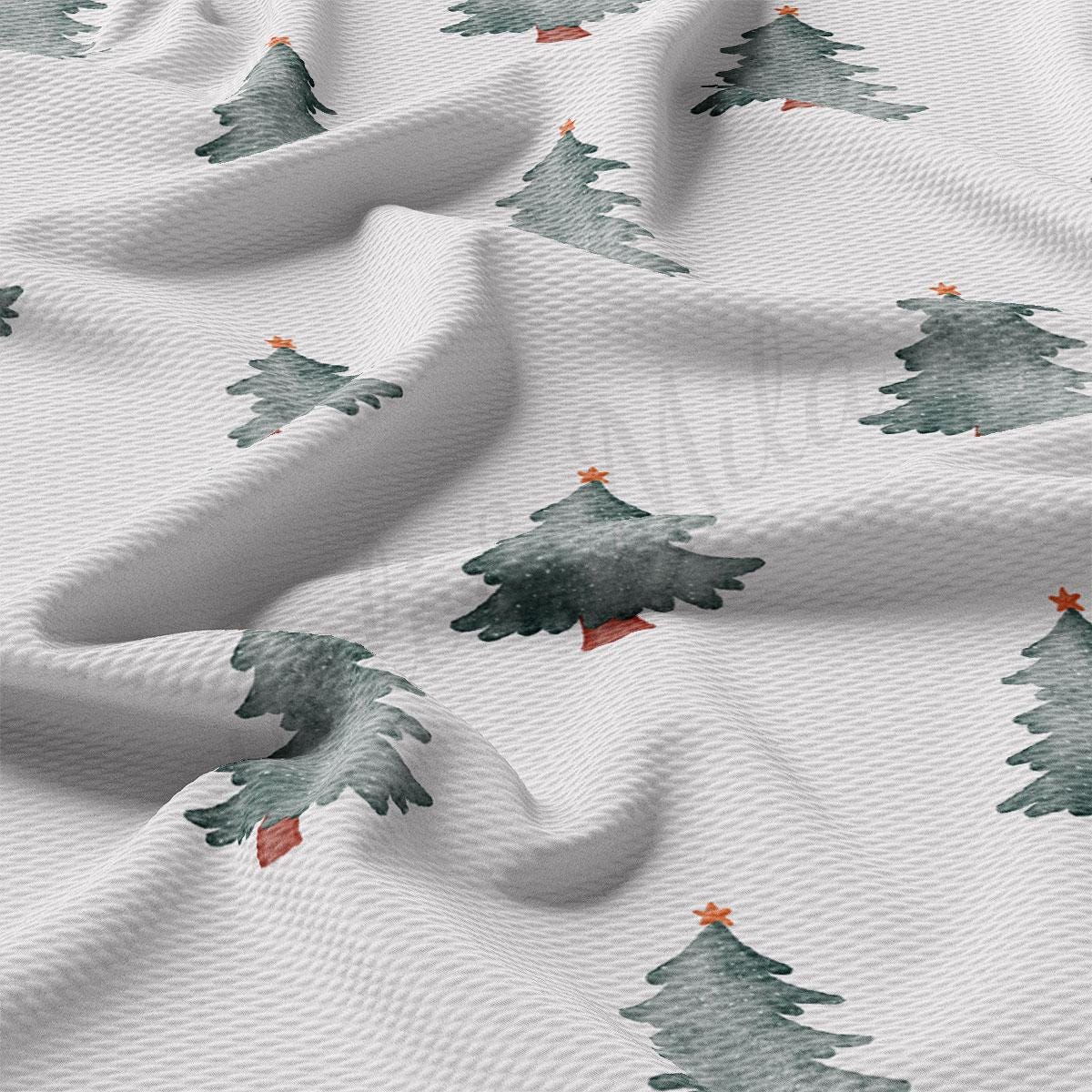 a close up of a white fabric with trees on it