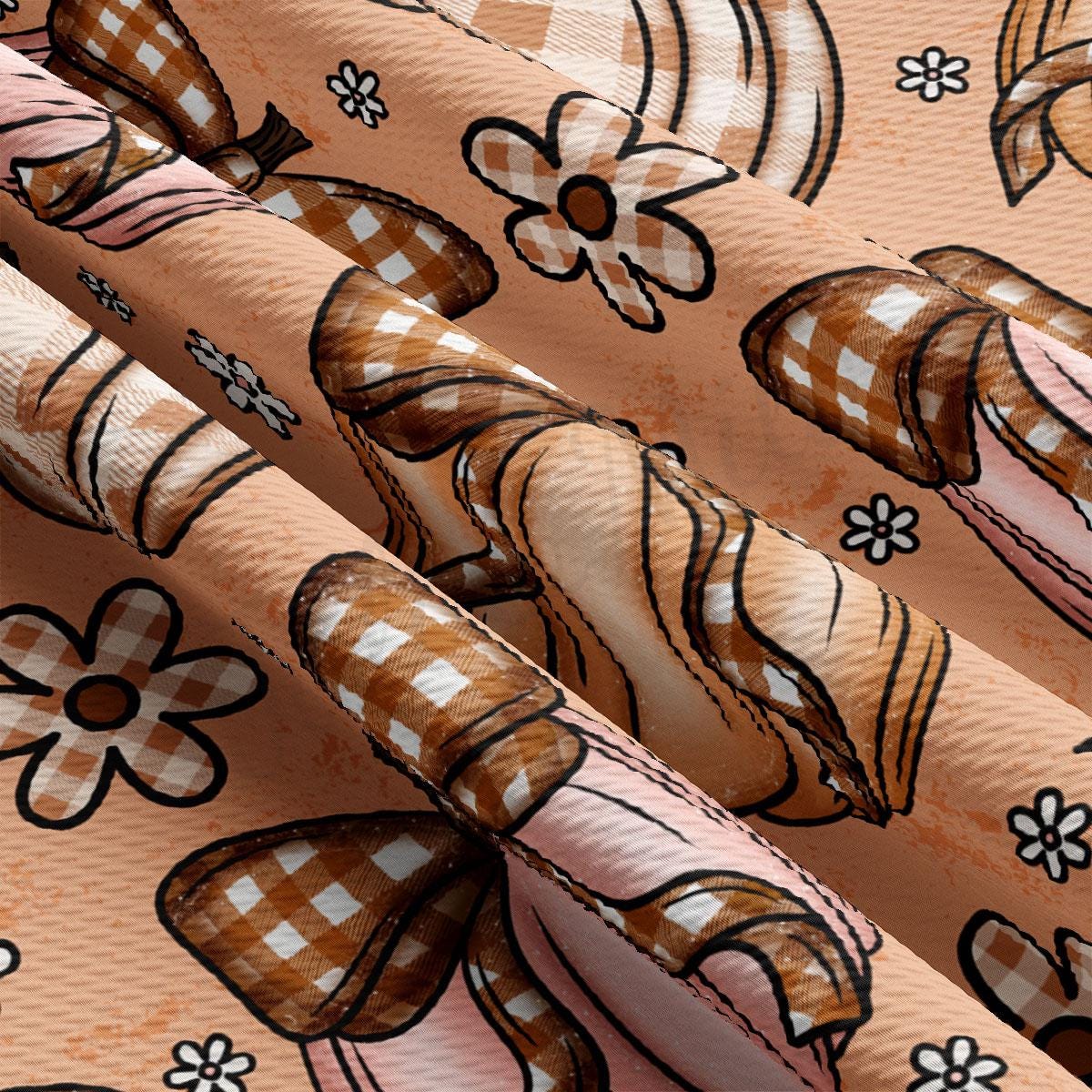The image is a close-up view of a fabric with a repeating pattern of brown and white checkered flowers and bows.