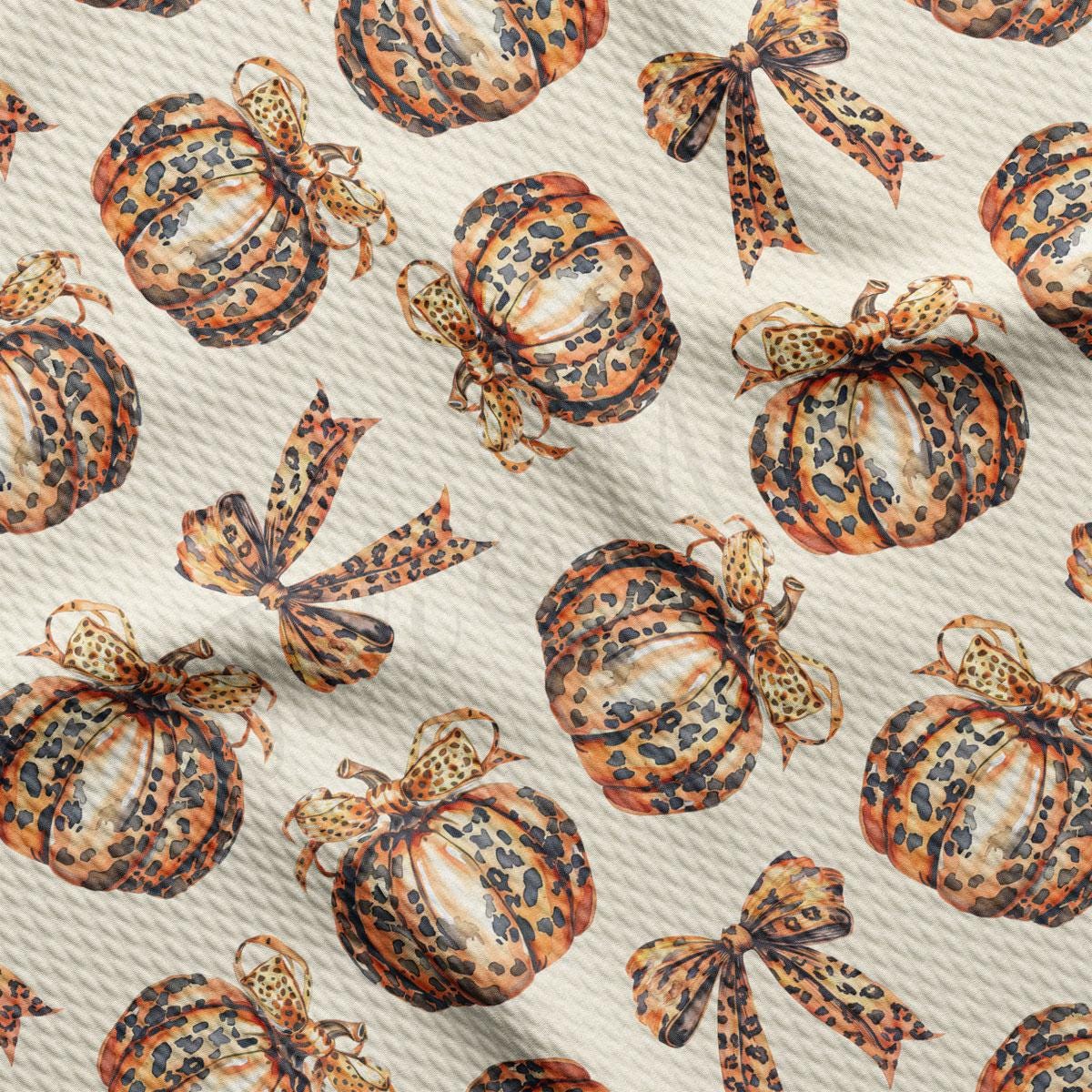 a repeating pattern of leopard print pumpkins and bows on a light-colored background.