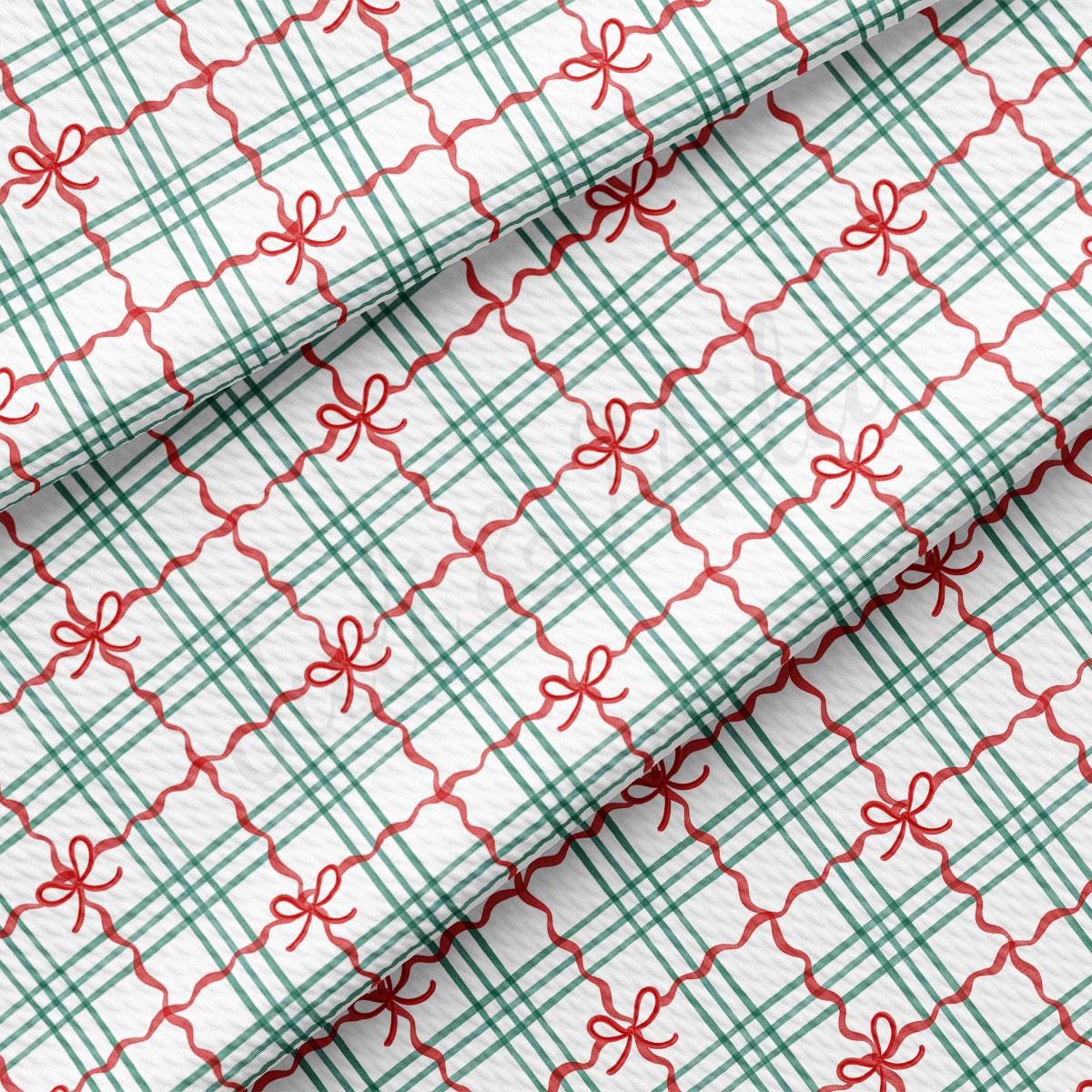 a close-up view of a fabric with a repeating pattern of green and red checkered lines and red bows.
