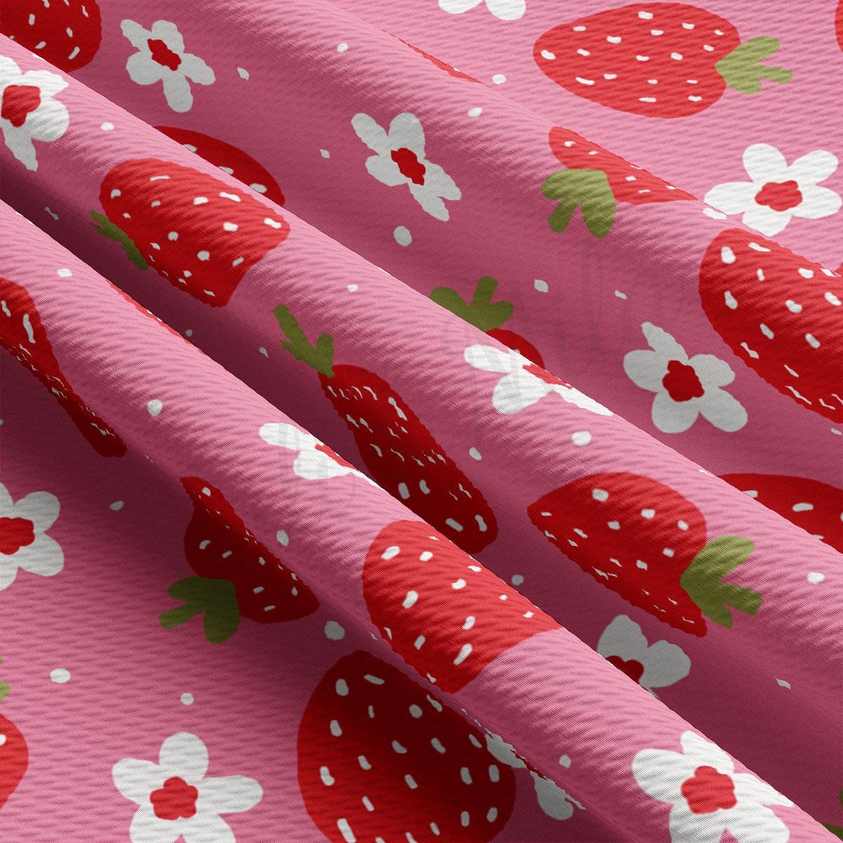 a close up of a pink fabric with strawberries on it