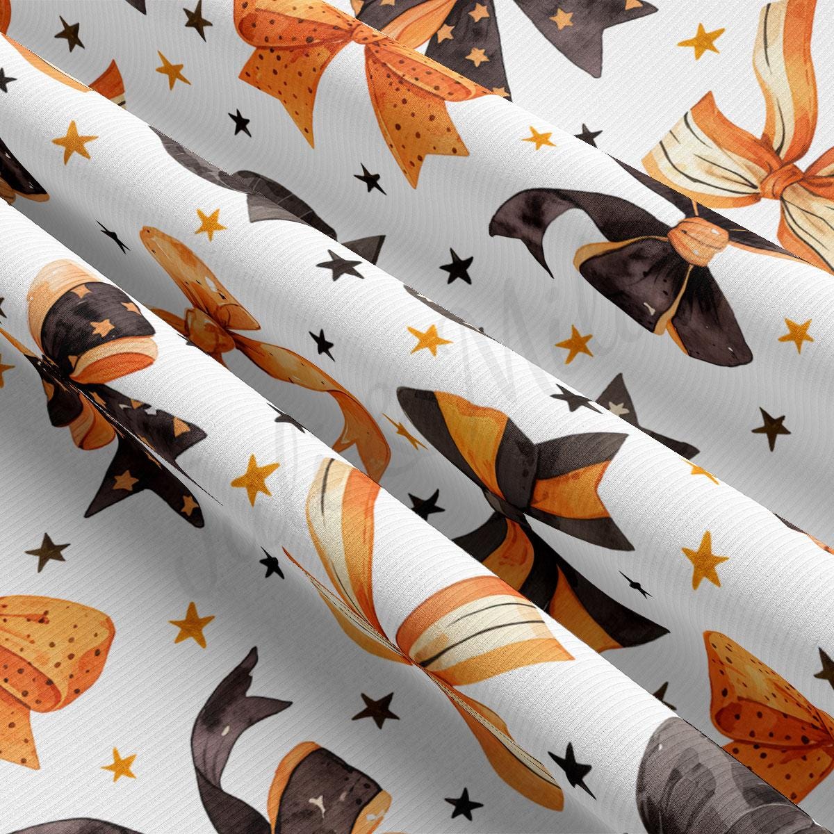 a close-up view of a fabric with a repeating pattern of orange and black bows and stars on a white background.