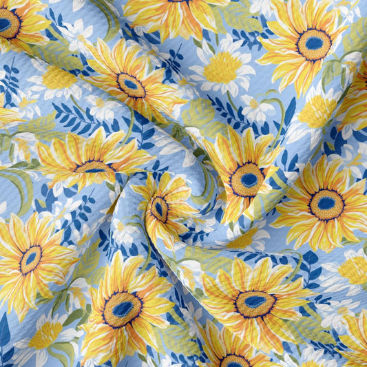 a sunflower print fabric with blue and yellow flowers