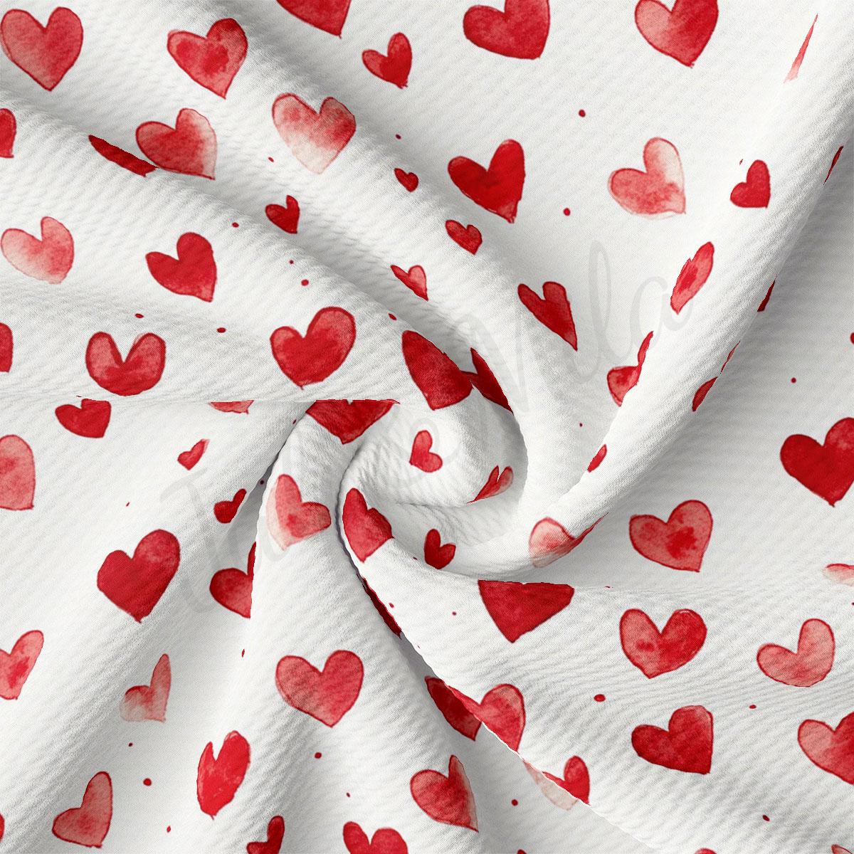 a close-up view of a fabric with a repeating pattern of red hearts on a white background.
