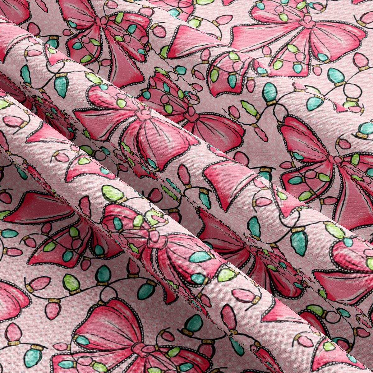 a close-up view of a fabric with a repeating pattern of pink bows and green leaves. The bows are arranged in a diagonal pattern, creating a sense of movement across the fabric. The green leaves are scattered throughout the fabric, adding a touch of nature to the overall design. The fabric appears to be made of a soft, plush material, suitable for clothing or home decor.