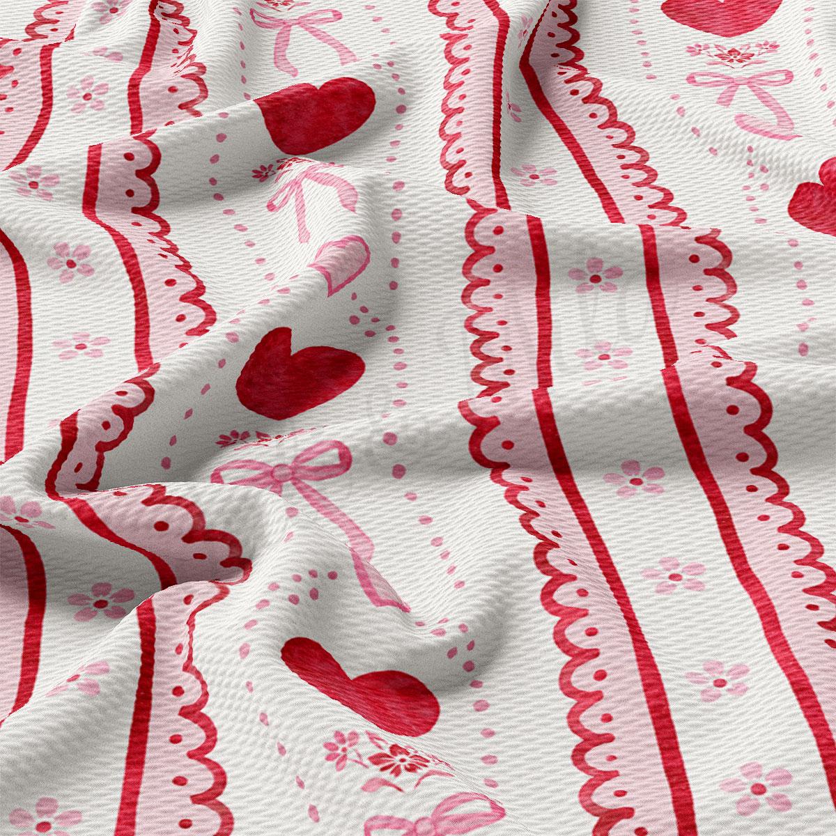 The image is a close-up view of a fabric with a repeating pattern of red hearts and pink flowers. The fabric appears to be crumpled, giving it a soft and delicate appearance.