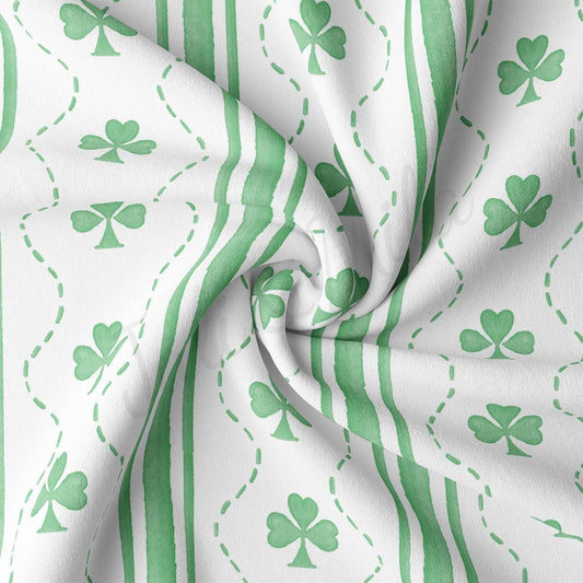 a green and white striped fabric with shamrocks on it