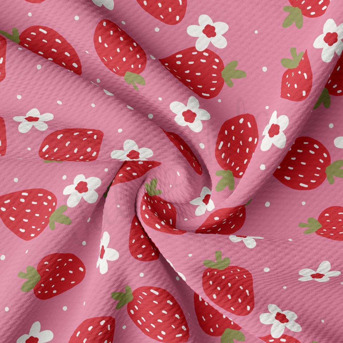 a close up of a pink fabric with strawberries on it