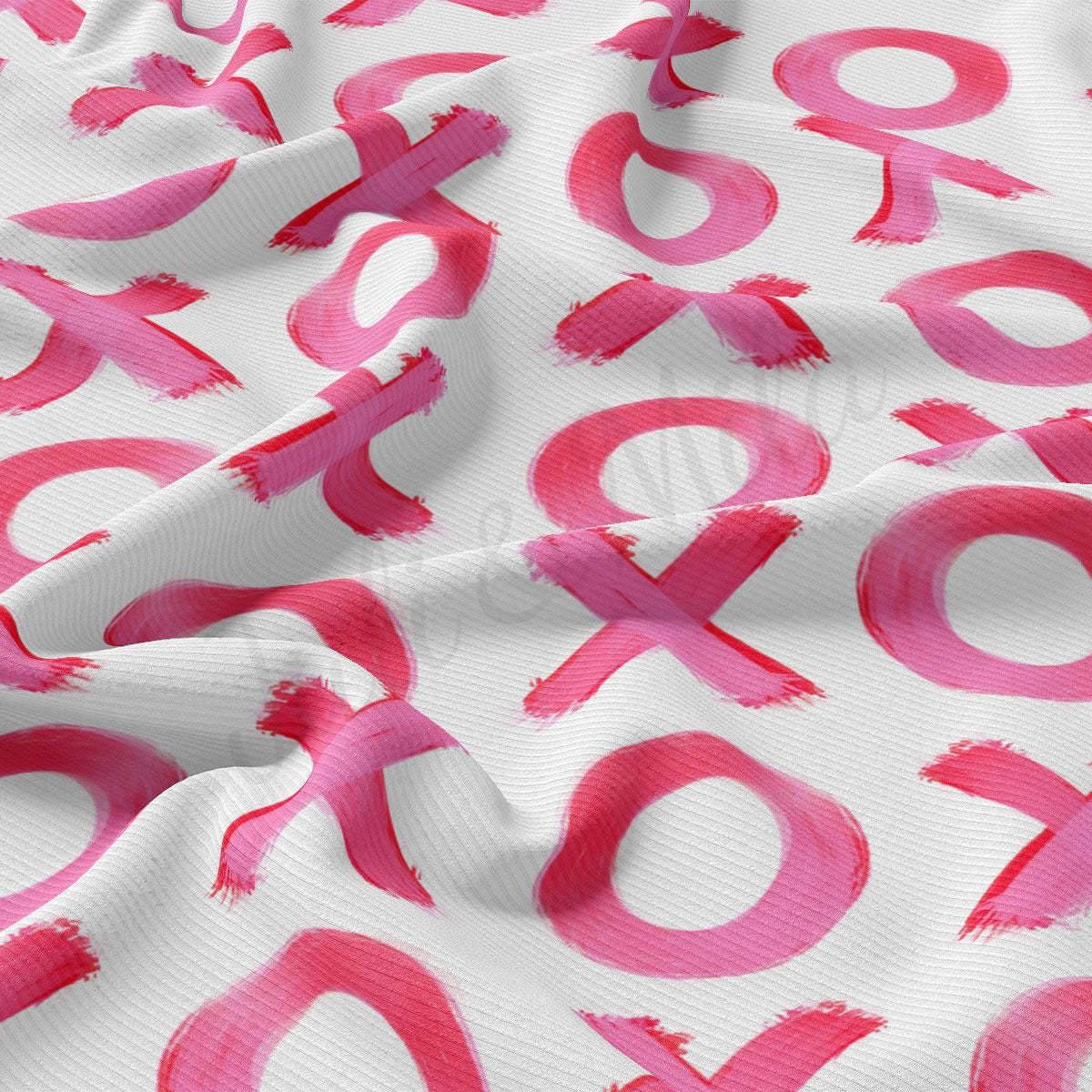 a white and pink fabric with pink letters on it