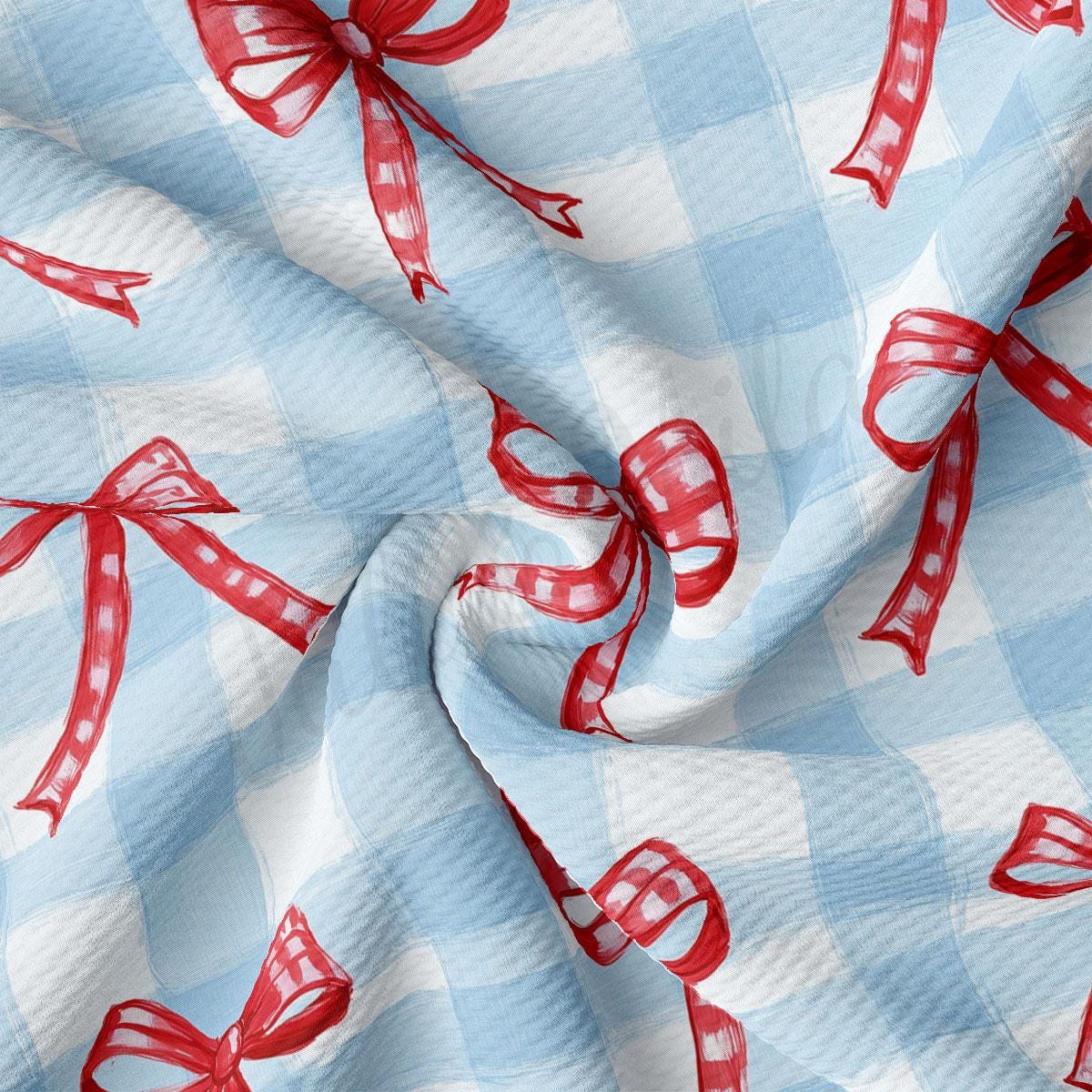a blue and white checkered fabric with red bows