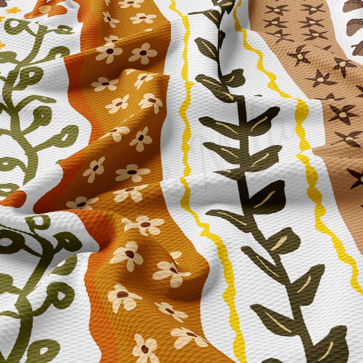 The image is a close-up of a fabric with a colorful, abstract pattern featuring various shapes and designs, including flowers, leaves, and geometric patterns.