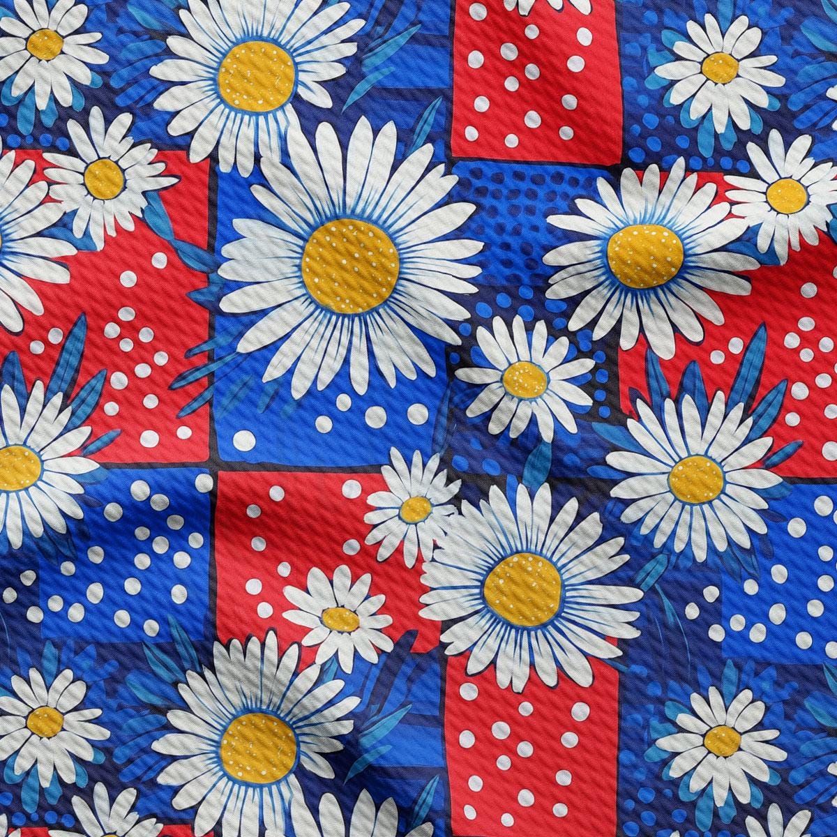 a red, white, and blue fabric with daisies on it