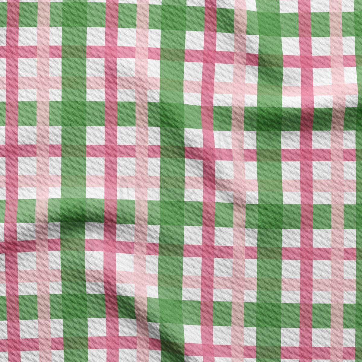 a green and pink checkered fabric with a white background