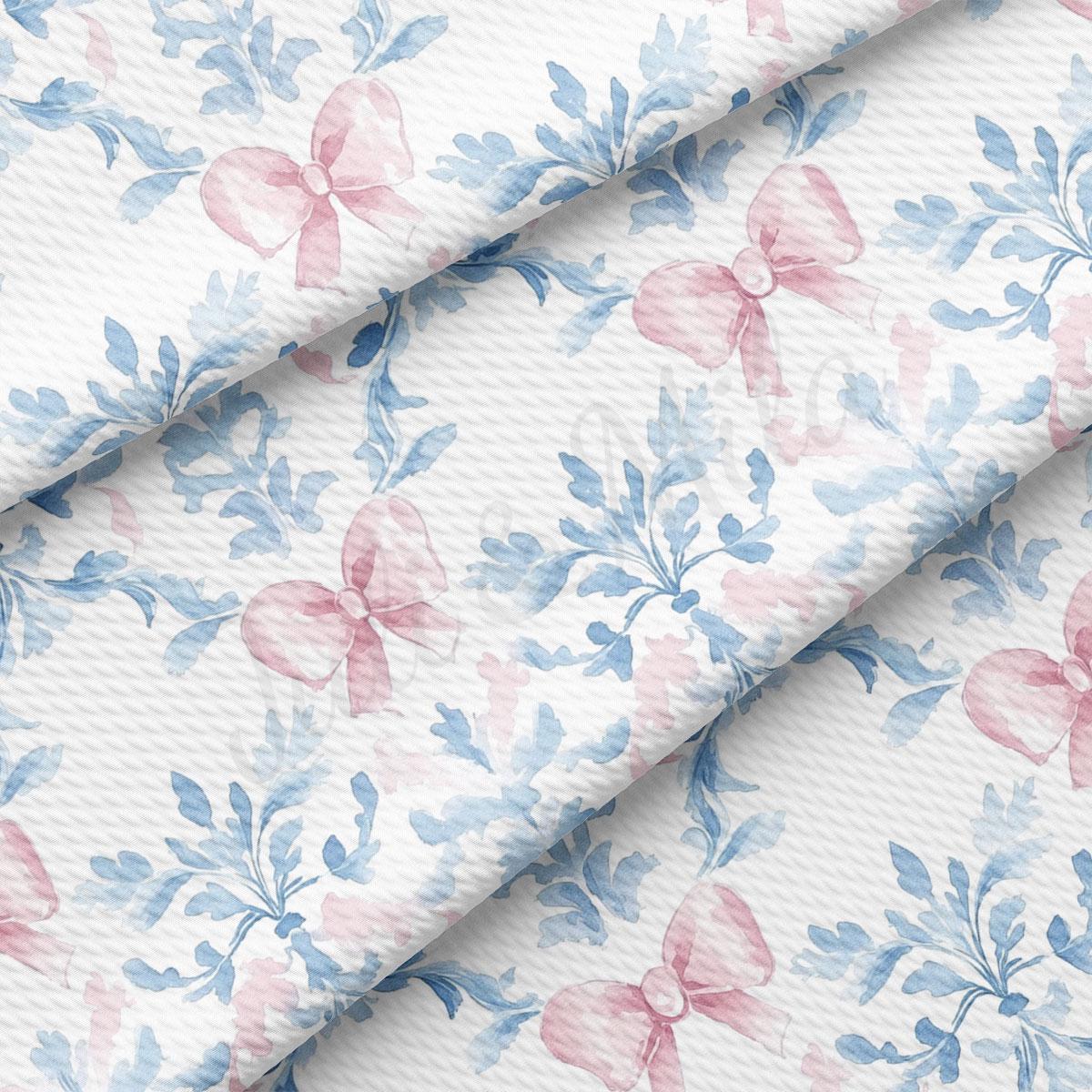 a repeating pattern of pink bows and blue leaves on a white background.