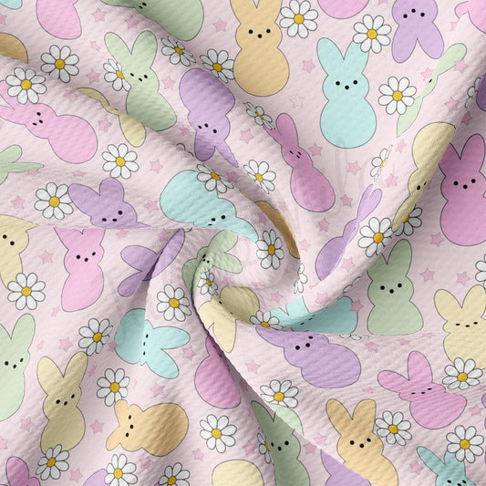 a close up of a pink fabric with a pattern of rabbits and flowers