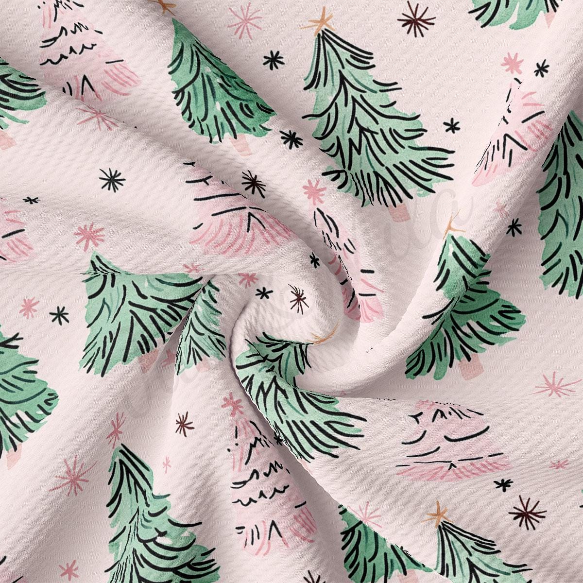 a close-up view of a fabric with a repeating pattern of green Christmas trees and pink stars.