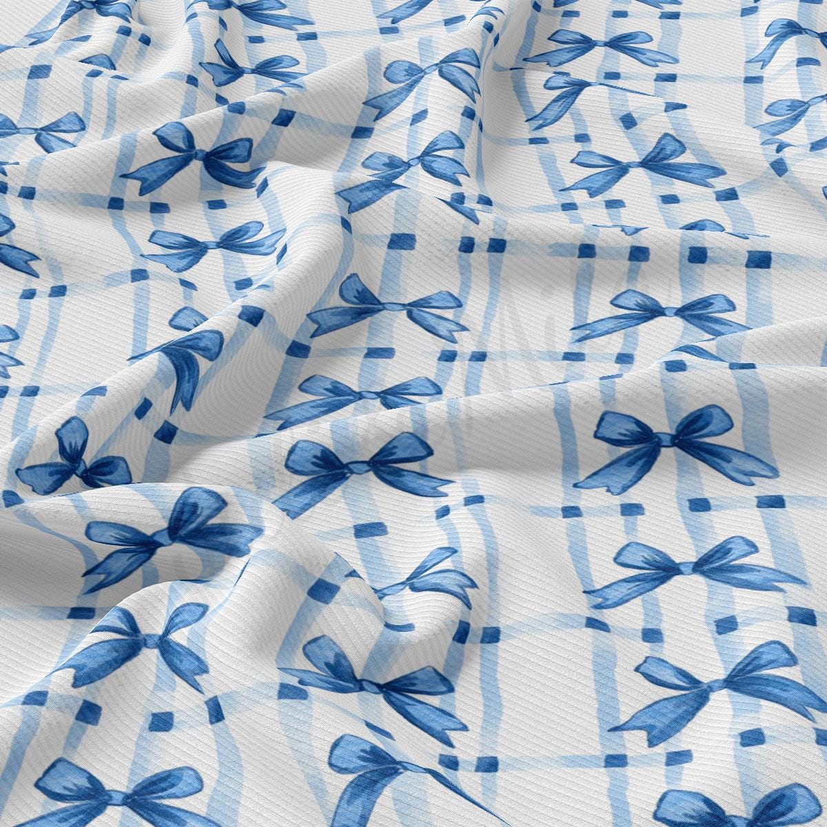 a blue and white checkered fabric with bows