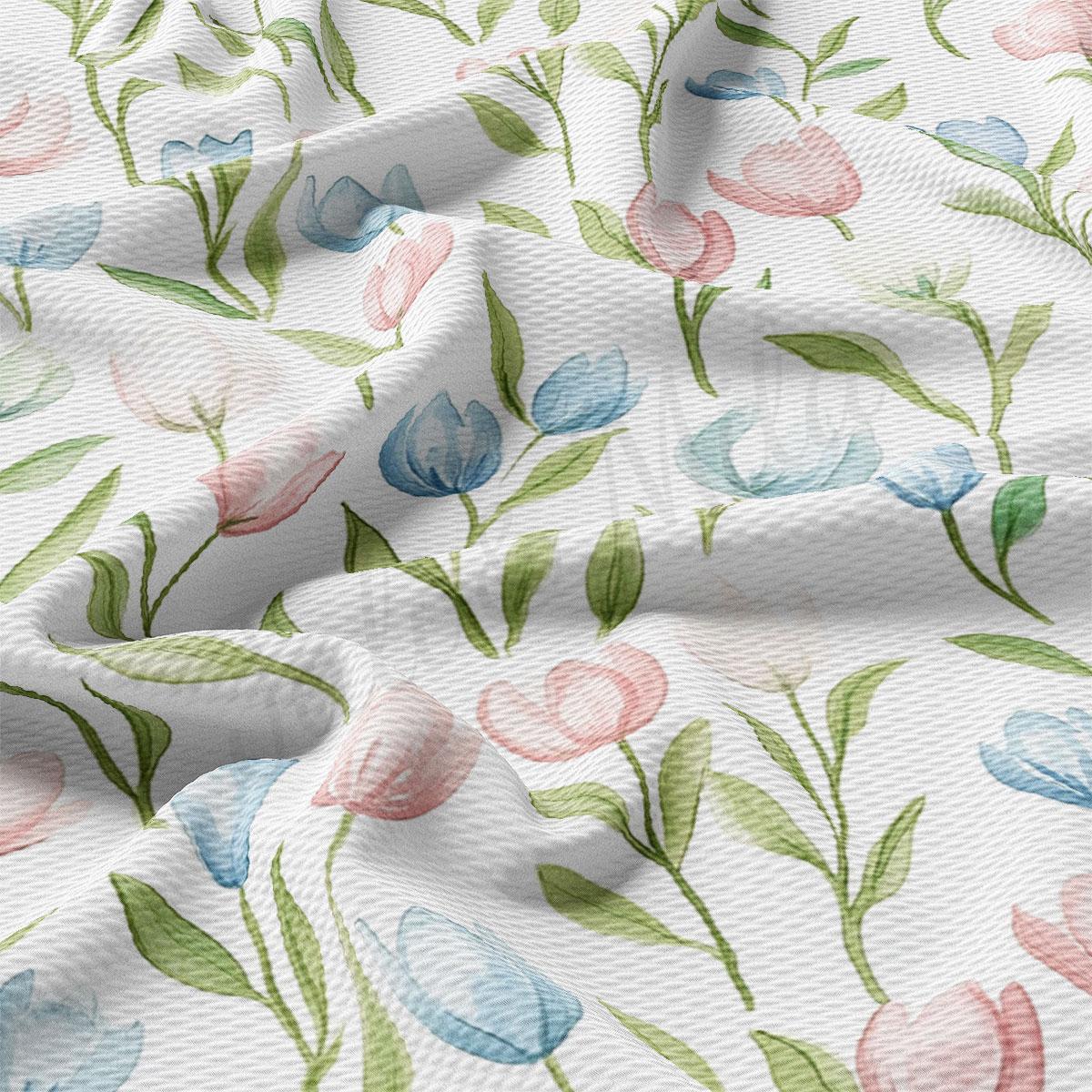 a close-up view of a fabric with a repeating floral pattern of pink, blue, and green flowers and leaves.