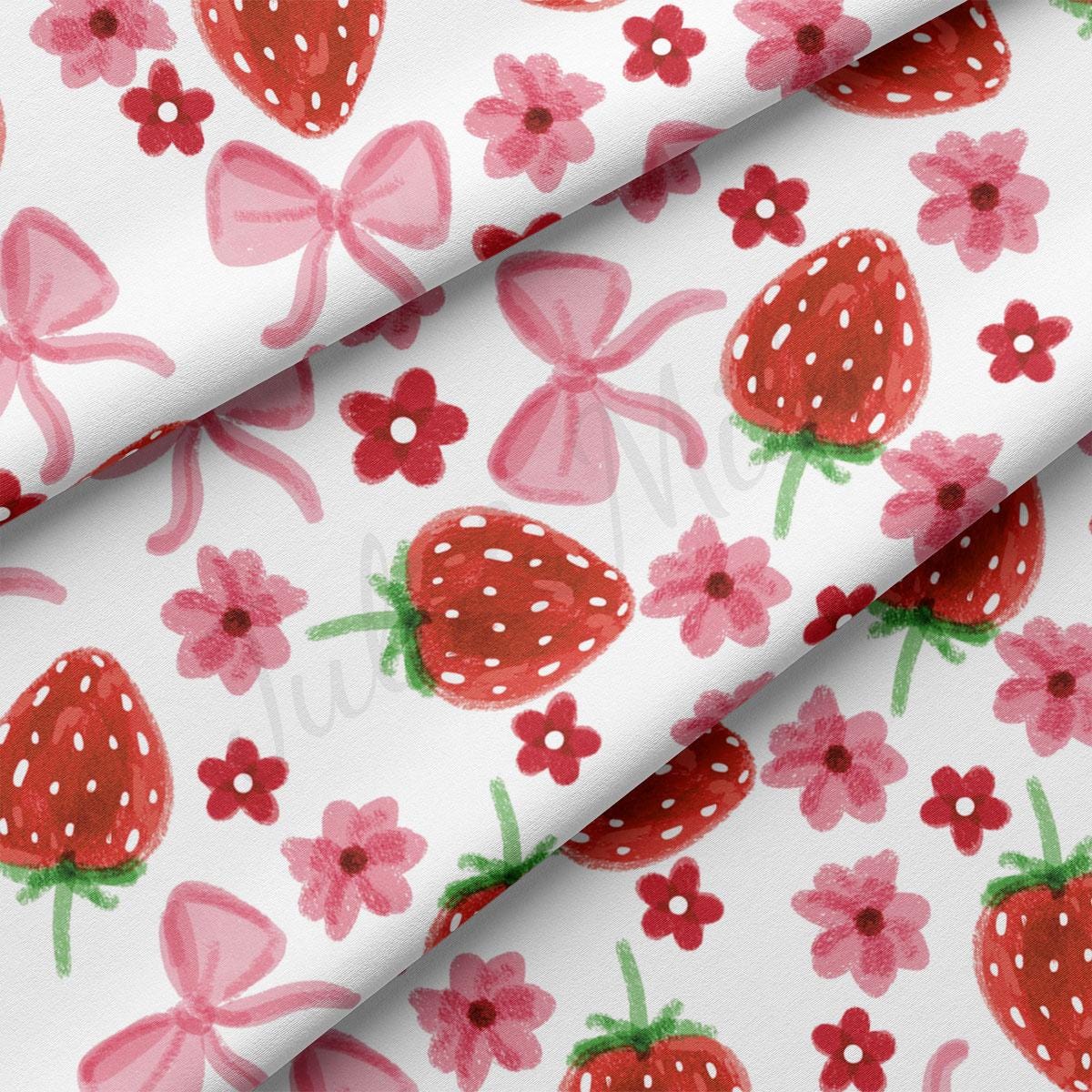 a close up of a pattern of strawberries and flowers