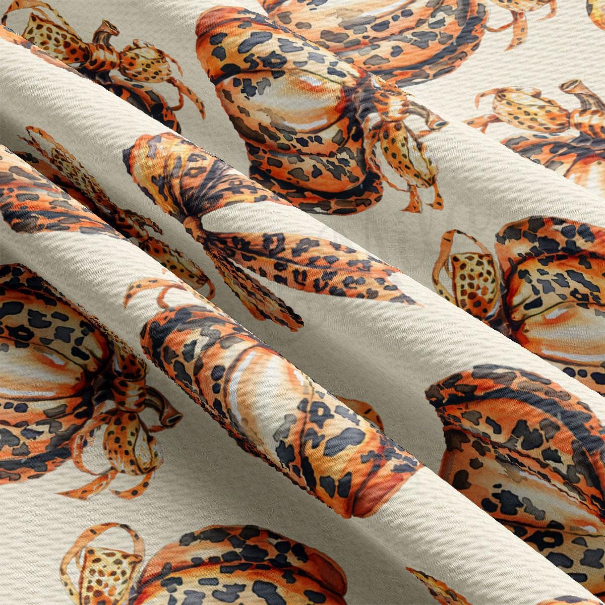 a close-up view of a fabric with a repeating pattern of leopard-like creatures, including snakes and lizards, against a white background.