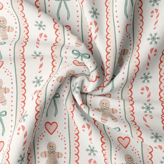 The image is a close-up of a fabric with a repeating pattern of gingerbread men, snowflakes, and candy canes. The pattern is predominantly white with red and green accents, creating a festive and holiday-themed design.