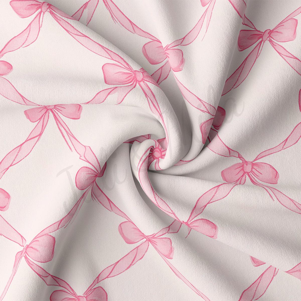 a close-up view of a fabric with a repeating pattern of pink bows on a white background.