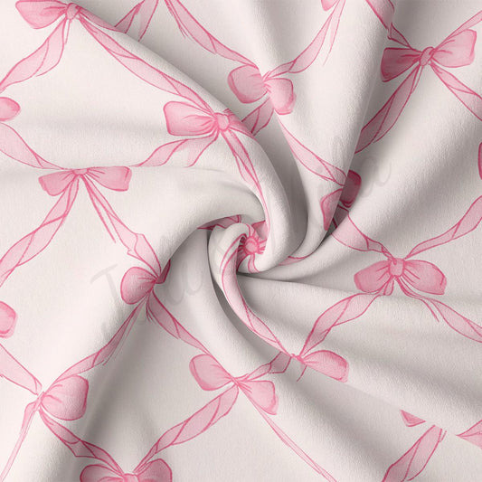 a close-up view of a fabric with a repeating pattern of pink bows on a white background.