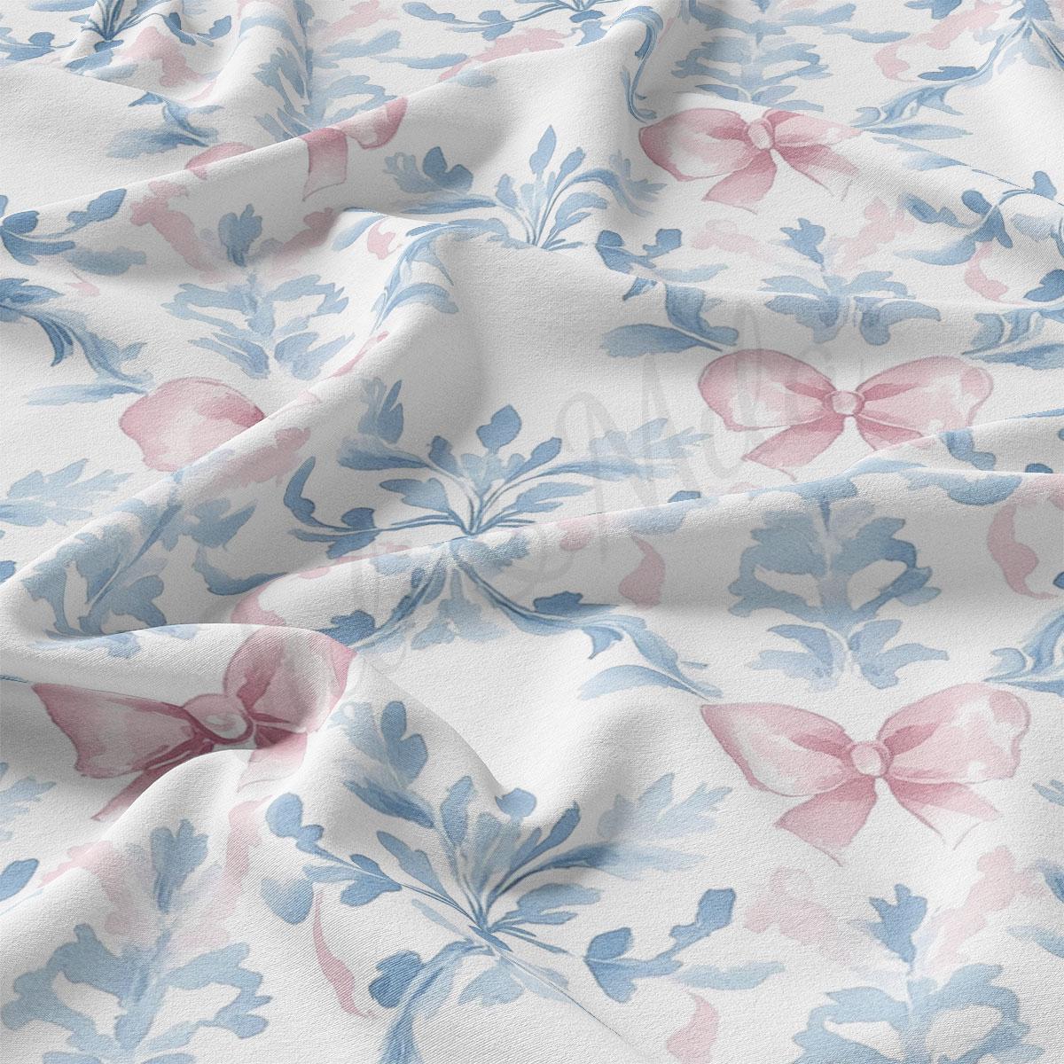 a close-up view of a fabric with a floral pattern, including pink and blue flowers and bows. The fabric appears to be crumpled, giving it a soft and delicate appearance.