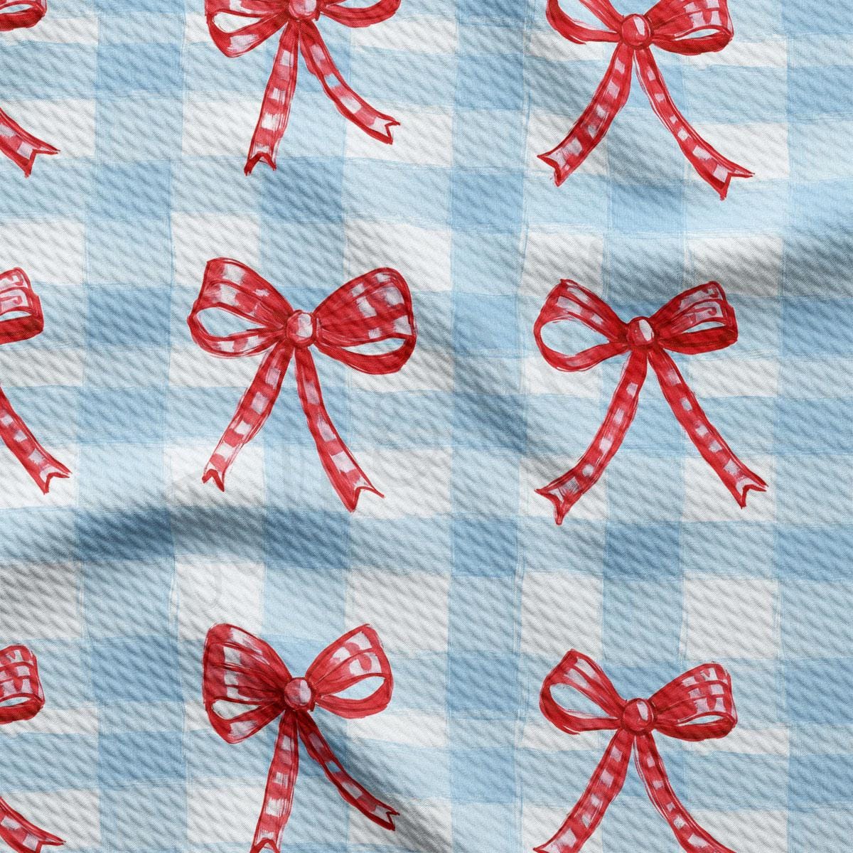 a blue and white checkered fabric with red bows