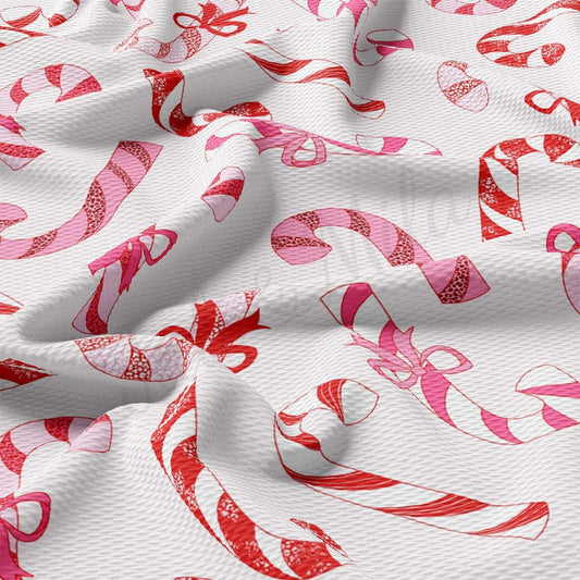 a close up of a white fabric with pink and red designs