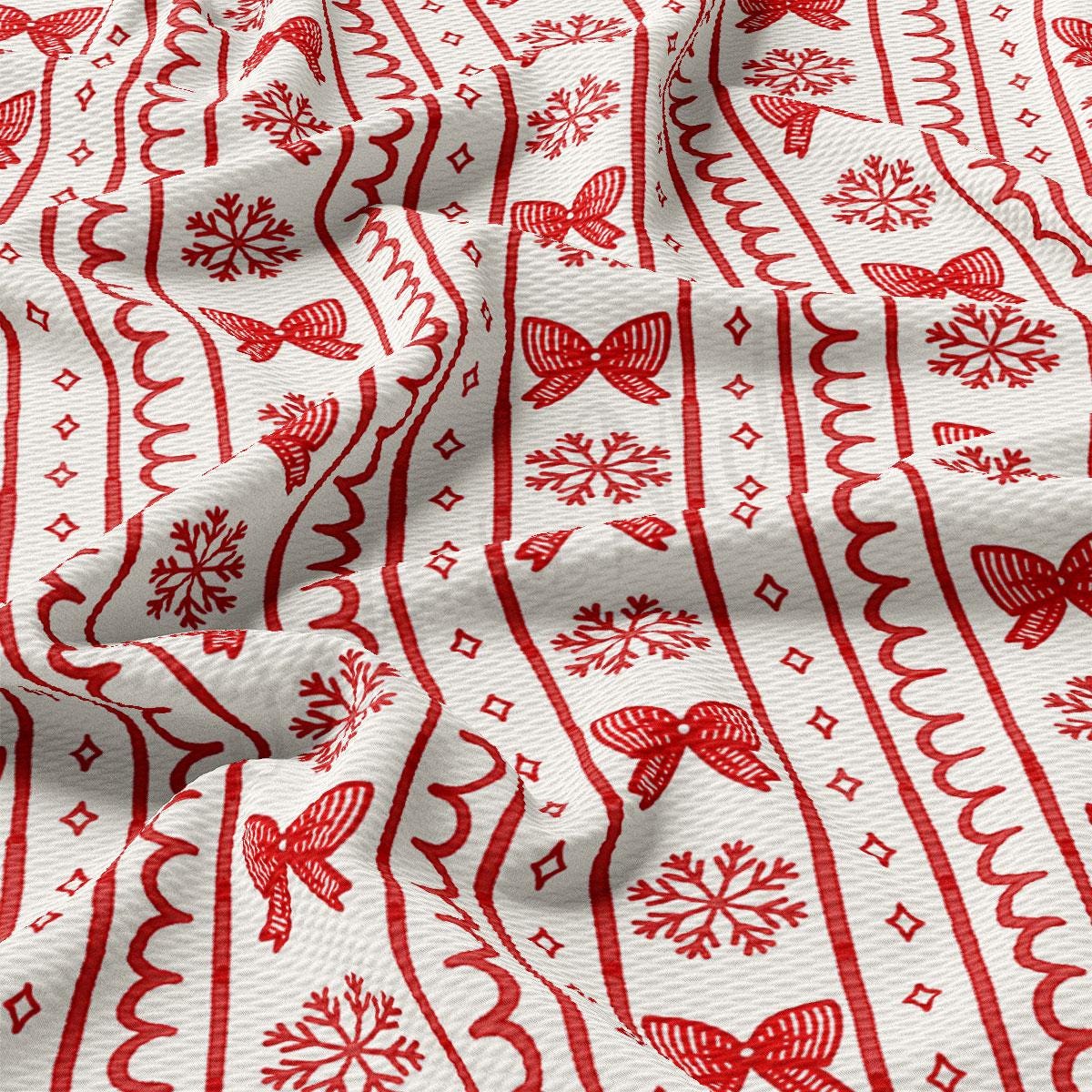 a close-up view of a fabric with a repeating pattern of red snowflakes and red bows.