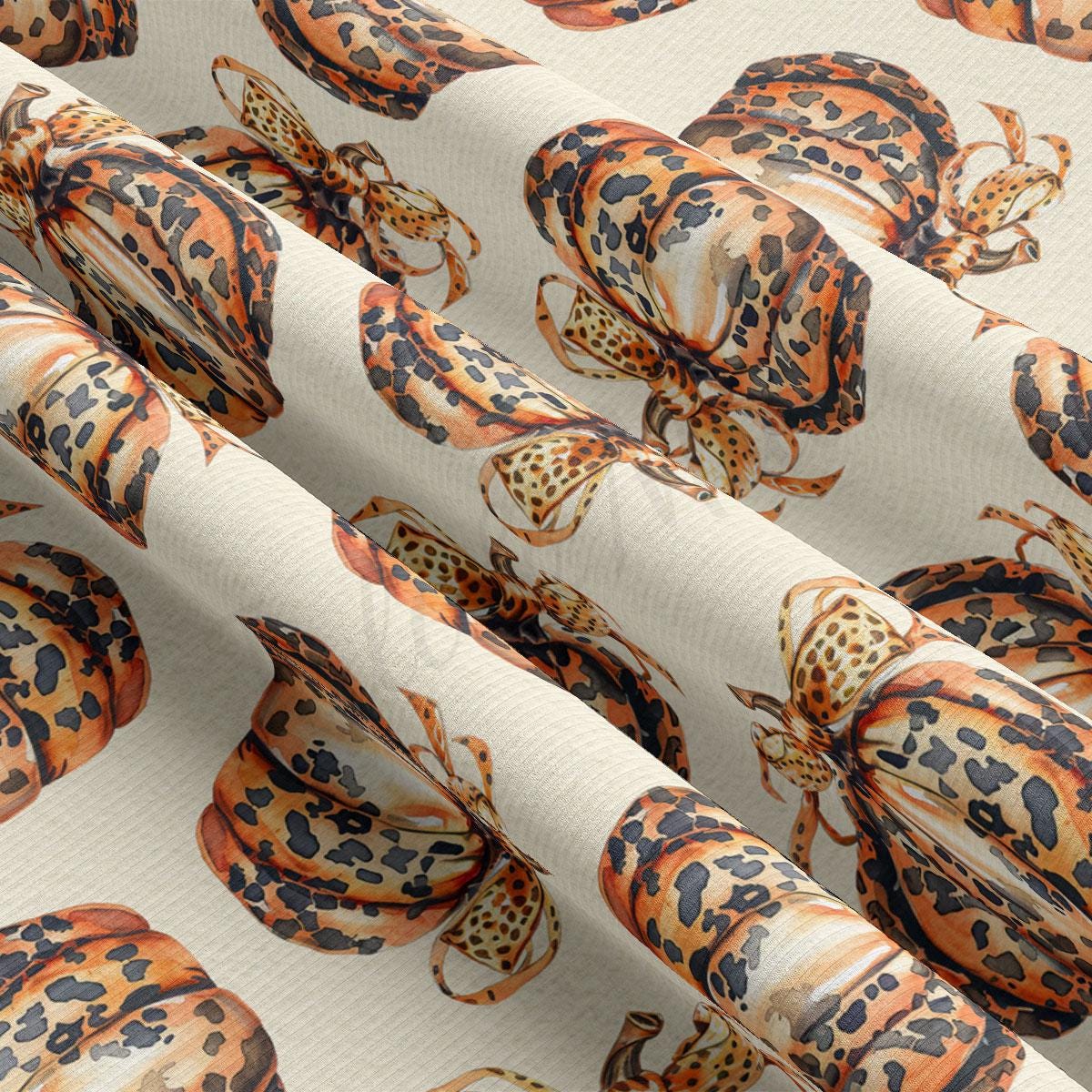 a close-up view of a fabric with a repeating pattern of leopard-print designs, including various shades of orange, black, and white.