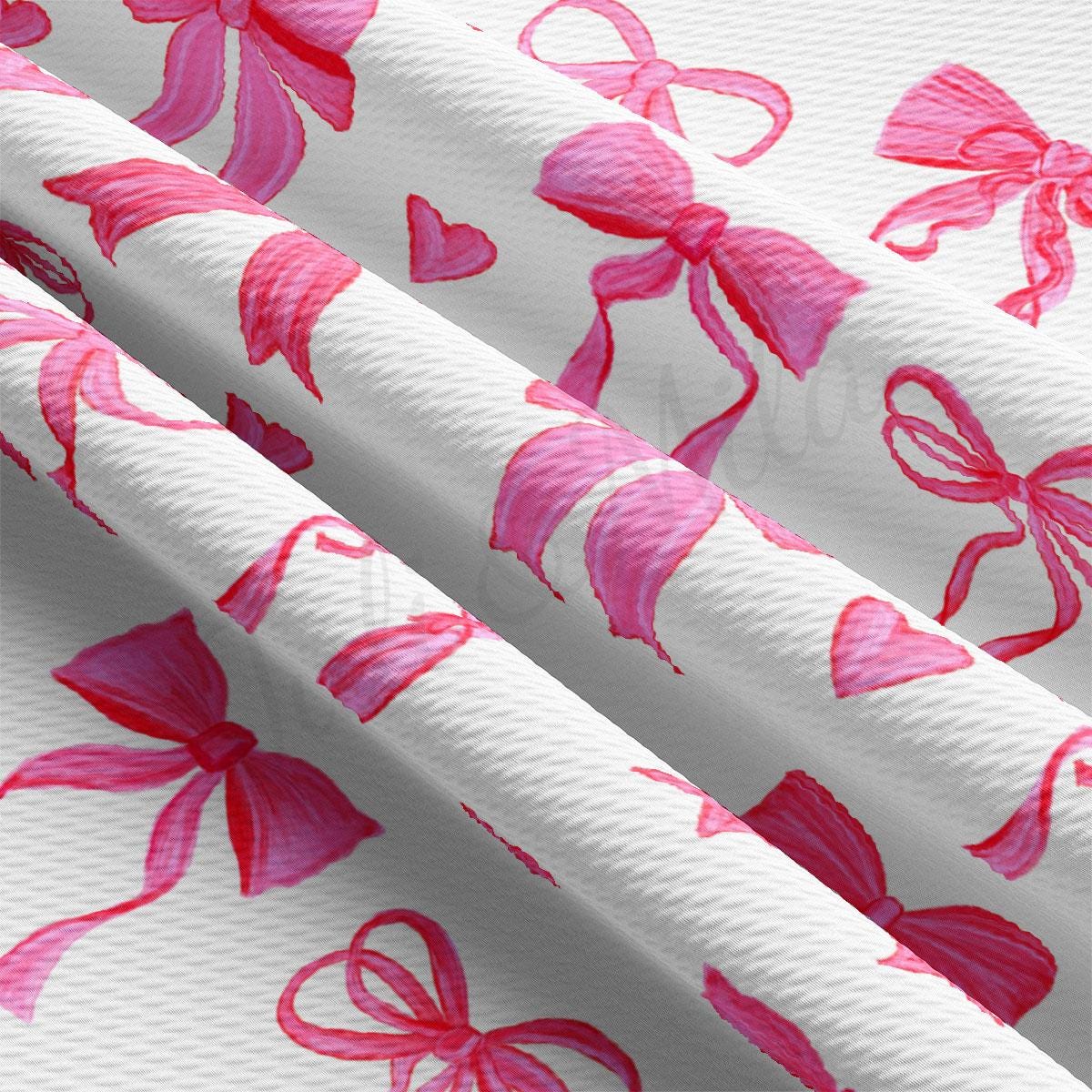 a close up of a pink ribbon on a white background