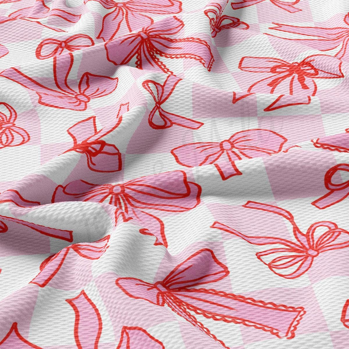 a pink and white checkered fabric with red bows