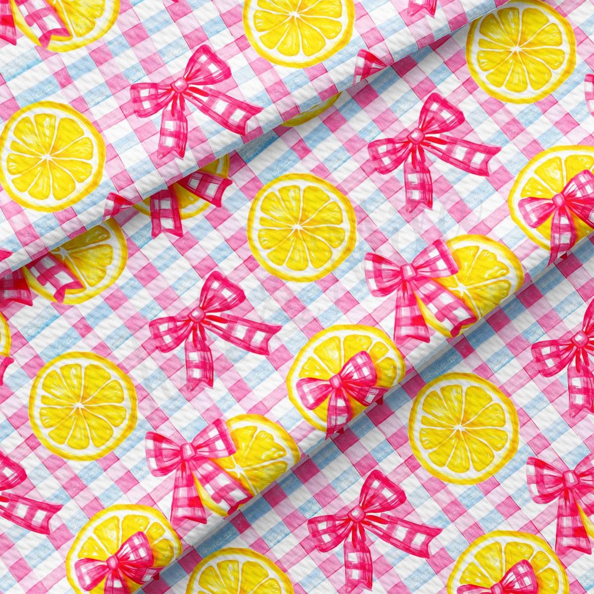 a pink and white checkered table cloth with lemons on it