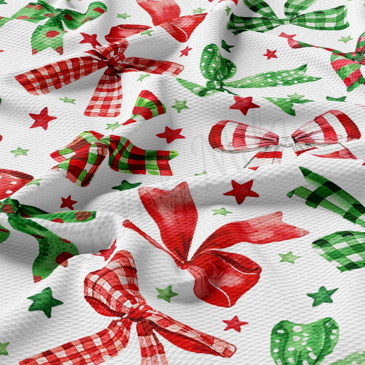 a close-up view of a fabric with a repeating pattern of red and green bows and stars. The bows appear to be made of a shiny material, giving the fabric a festive and holiday-themed appearance.