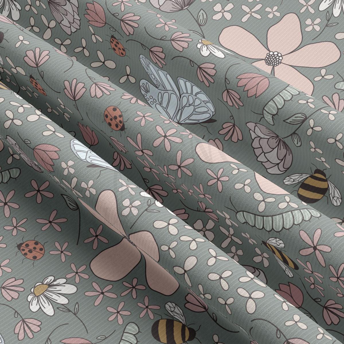 a close up of a curtain with flowers and bugs on it