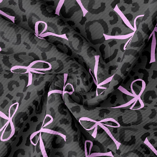 a close up of a pink ribbon on a gray background