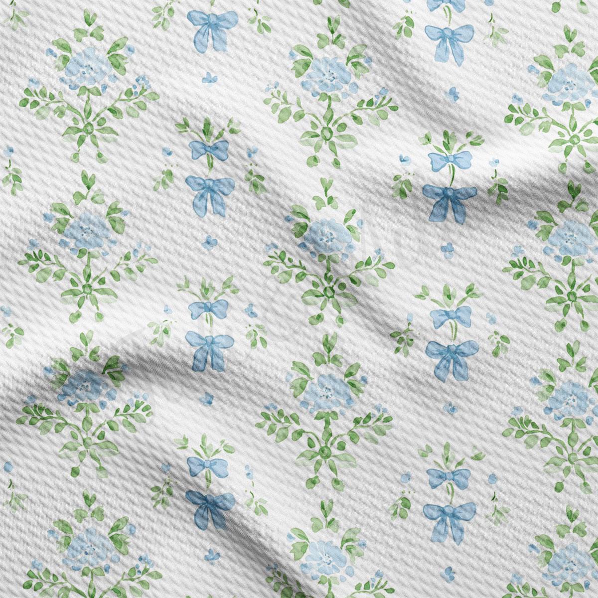 a repeating pattern of blue flowers and green leaves on a white background.