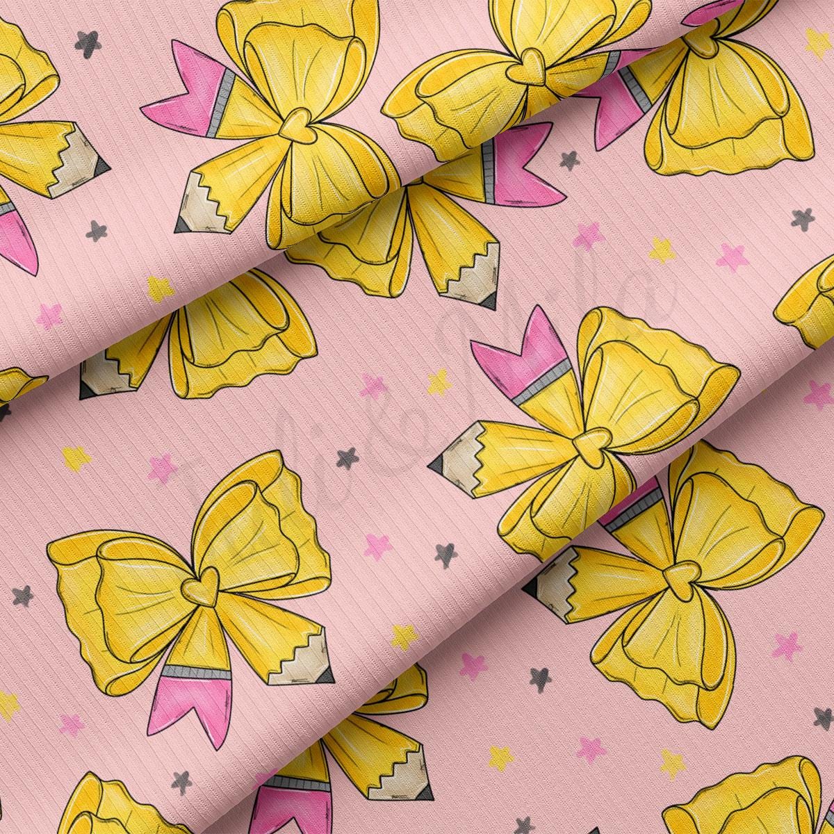 a repeating pattern of yellow pencils with bows on a pink background, along with small pink and yellow stars scattered throughout the pattern.