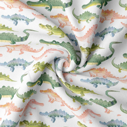 a close up of a white fabric with green and orange alligators on it