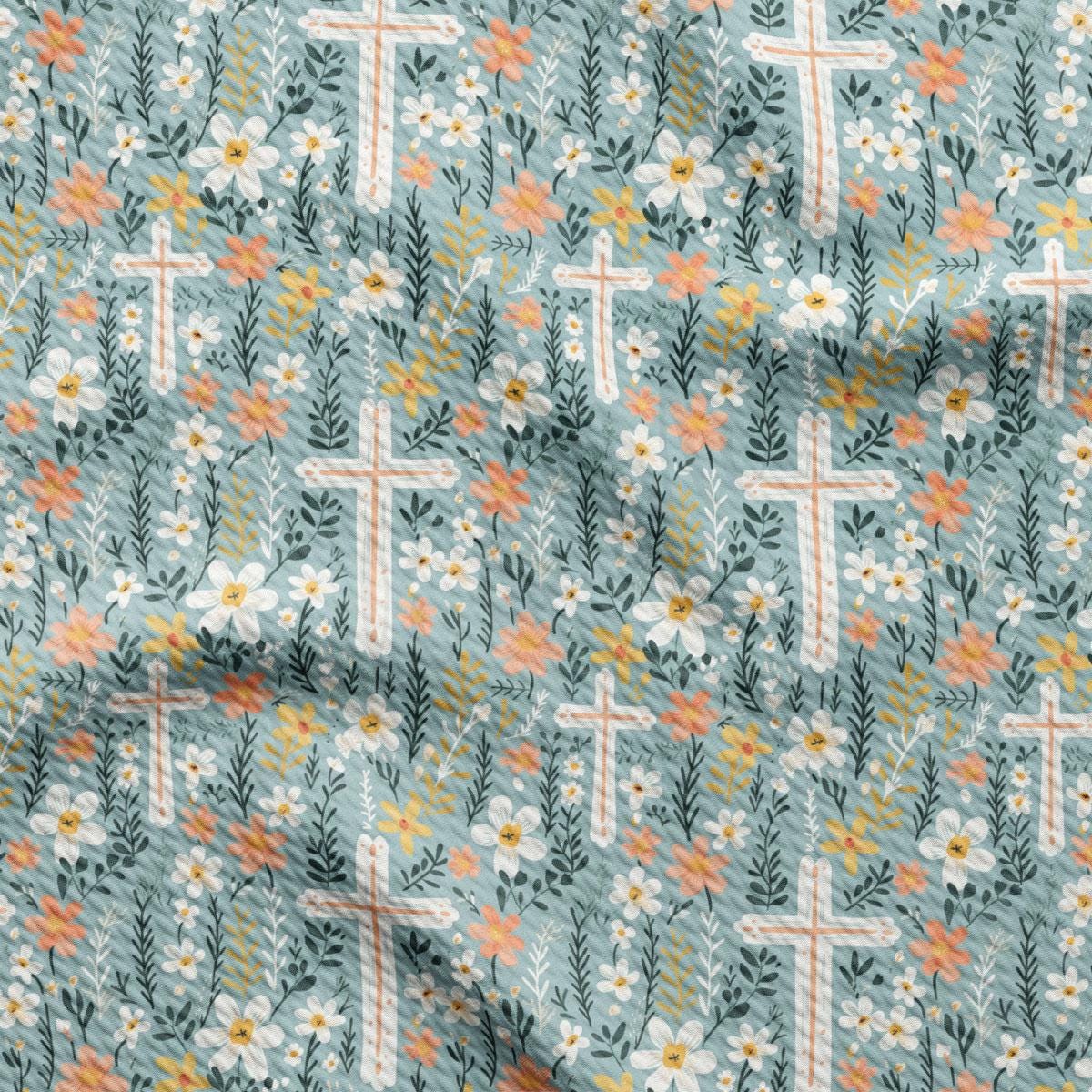 a close up of a fabric with flowers and crosses on it