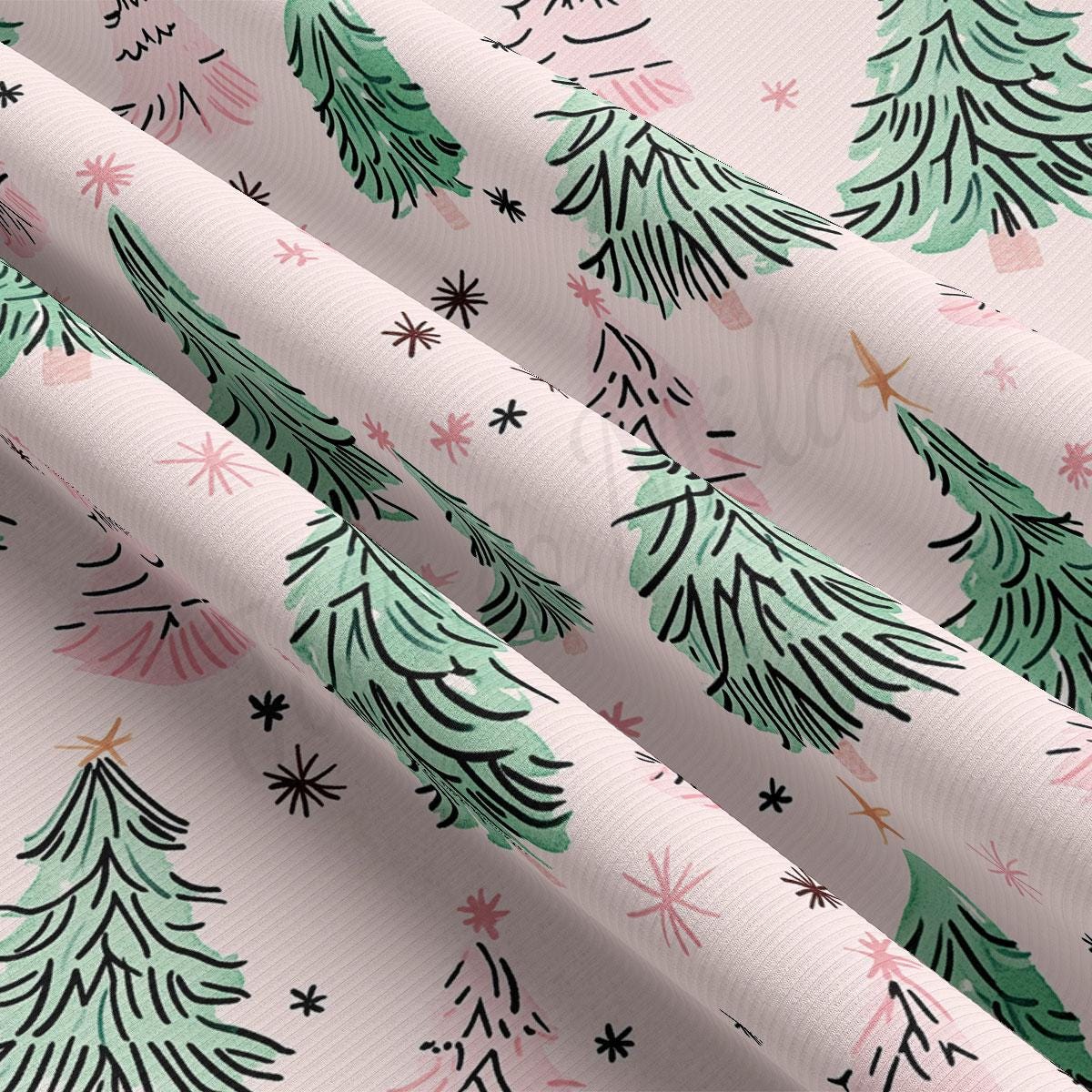 a close-up view of a fabric with a repeating pattern of green Christmas trees and small white stars.