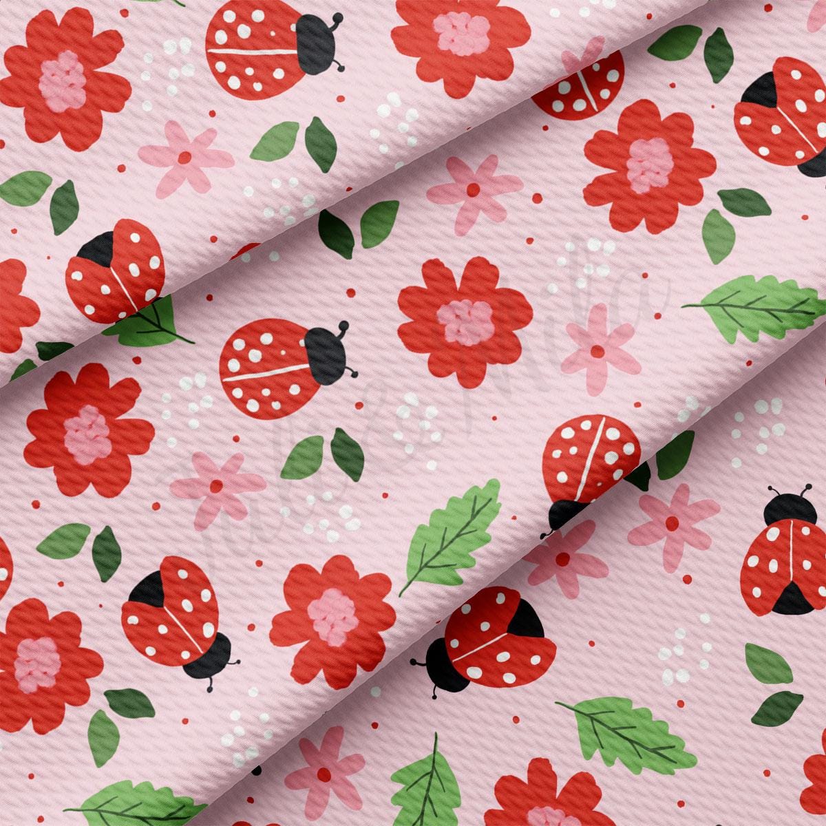a pink background with ladybugs and flowers