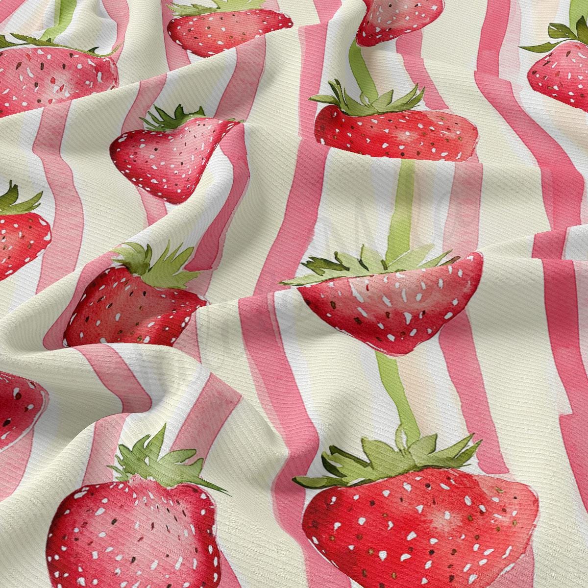 a pink and white striped fabric with strawberries on it