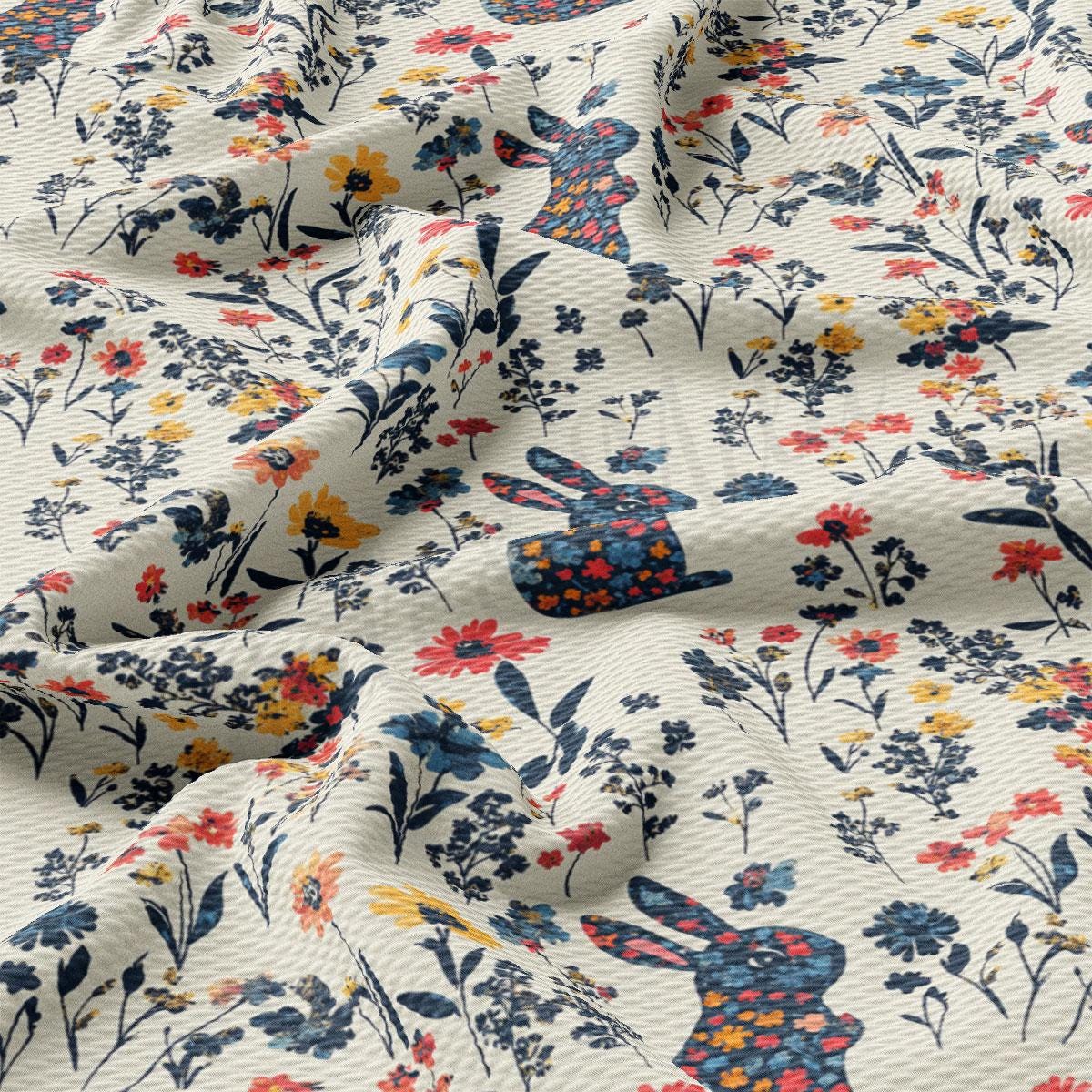 a close up of a fabric with a pattern of flowers and rabbits
