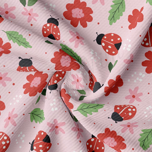 a close up of a pink fabric with ladybugs on it