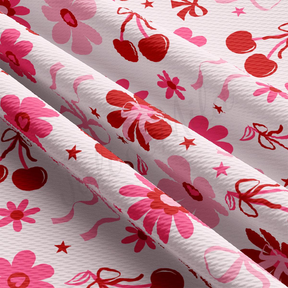 a close up of a pink and red flowered fabric