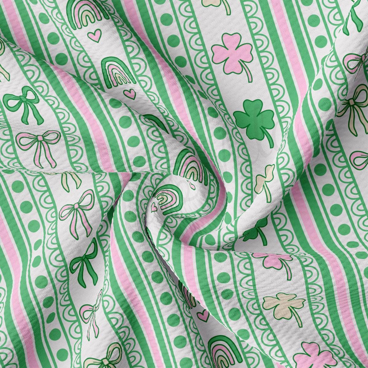 a green and pink striped fabric with shamrocks on it